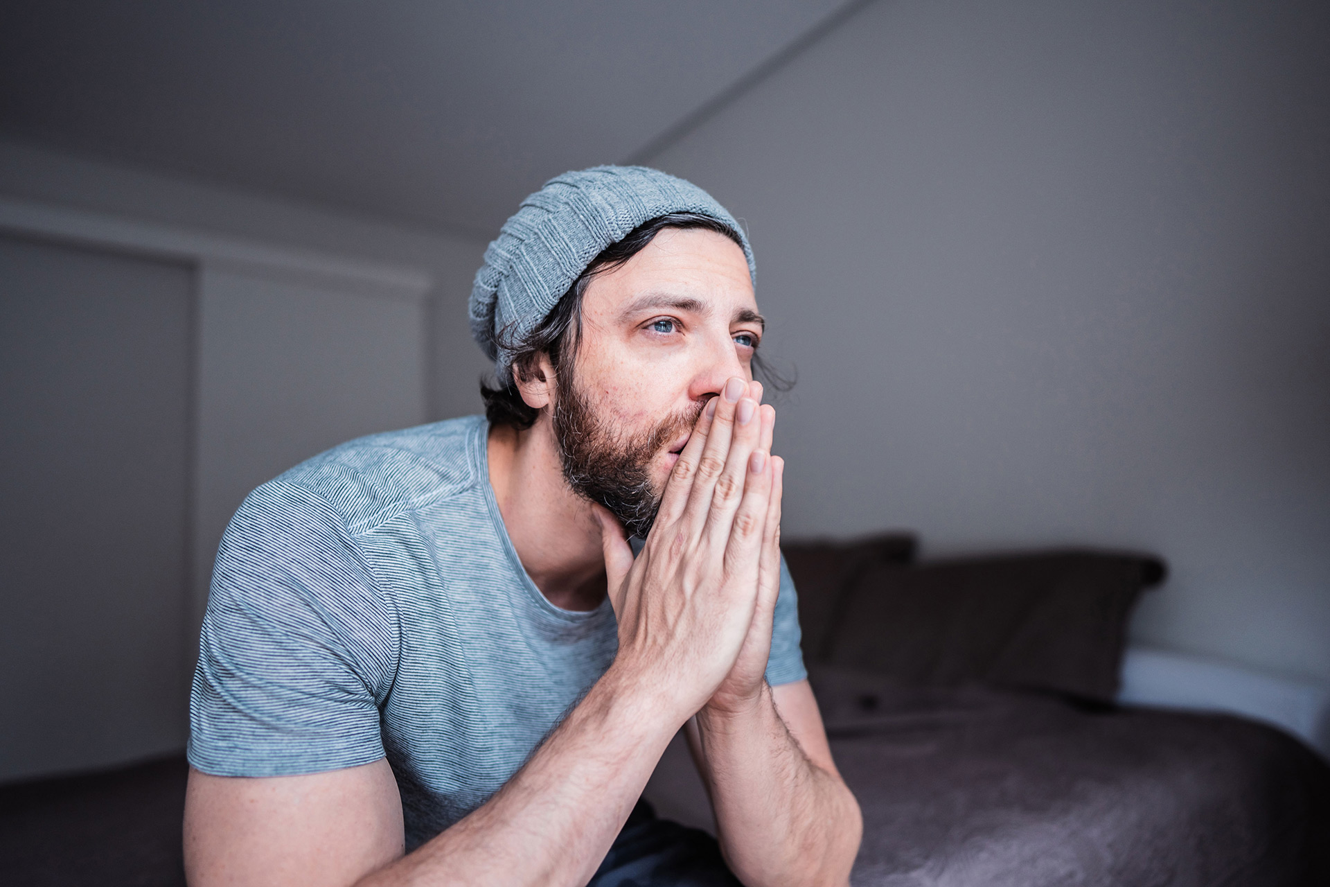 Man in tears with folded hands